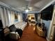 A well-lit living room with a sofa and a view into the Main Bedroom at 1101 Alcazar S Way, St Petersburg, FL 33705
