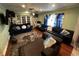 Living room showcasing the blue sofa, textured rug, modern furniture, and a built-in office space at 1101 Alcazar S Way, St Petersburg, FL 33705