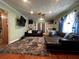 Cozy living room features a textured rug, modern furniture, and a built-in office space at 1101 Alcazar S Way, St Petersburg, FL 33705
