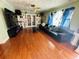 Spacious living room boasts hardwood floors, modern furniture, and custom built-in shelving at 1101 Alcazar S Way, St Petersburg, FL 33705