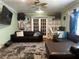 Inviting living room with plush rug, stylish sofas, built-in shelving, and natural light at 1101 Alcazar S Way, St Petersburg, FL 33705
