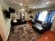 Inviting living room with plush rug, stylish sofas, built-in shelving, and natural light at 1101 Alcazar S Way, St Petersburg, FL 33705