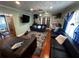 Living room showcasing the blue sofa, textured rug, modern furniture, and a built-in office space at 1101 Alcazar S Way, St Petersburg, FL 33705