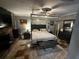 This Main Bedroom features a stone fireplace, four-poster bed, ceiling fan, and tiled flooring at 1101 Alcazar S Way, St Petersburg, FL 33705