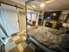 Cozy main bedroom with a bed, stone fireplace and tile floors at 1101 Alcazar S Way, St Petersburg, FL 33705