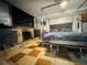 Bedroom features a bed, stone fireplace, dresser and tile floors at 1101 Alcazar S Way, St Petersburg, FL 33705