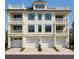 Stunning three-story townhome with multiple balconies and three garage doors at 1104 Pass A Grille Way, St Pete Beach, FL 33706
