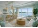 Bright and airy living room featuring waterfront views and wicker pendant lighting at 1104 Pass A Grille Way, St Pete Beach, FL 33706