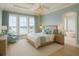 Serene main bedroom with water views, elegant lighting, and a spa-like ensuite at 1104 Pass A Grille Way, St Pete Beach, FL 33706