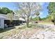 Backyard featuring a patio, green grass, mature trees, and an above ground swimming pool at 11314 Silverleaf Ct, Riverview, FL 33579