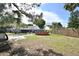 Backyard featuring a patio, green grass, mature trees, and an above ground swimming pool at 11314 Silverleaf Ct, Riverview, FL 33579
