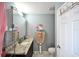 Bathroom with vanity, mirror, toilet and towel rack near the decorative door at 11314 Silverleaf Ct, Riverview, FL 33579