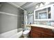 Bathroom with vanity, mirror, toilet, and shower/tub combo with colorful curtain at 11314 Silverleaf Ct, Riverview, FL 33579