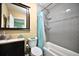 Bathroom featuring tiled shower-tub, vanity, toilet, and framed mirror at 11314 Silverleaf Ct, Riverview, FL 33579