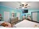 Stylish bedroom features a ceiling fan, hardwood floors, modern decorations, and ample storage at 11314 Silverleaf Ct, Riverview, FL 33579