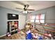 Bedroom featuring a TV, wood floors, and a whimsical framed playhouse bed at 11314 Silverleaf Ct, Riverview, FL 33579