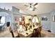 Dining room with decorative table and chairs, with kitchen and living space in background at 11314 Silverleaf Ct, Riverview, FL 33579