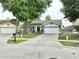 Charming single-story home with a well-manicured lawn, a two-car garage, and a welcoming front porch area at 11314 Silverleaf Ct, Riverview, FL 33579