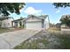 Charming single-story home with a well-manicured lawn, a two-car garage, and a welcoming front porch area at 11314 Silverleaf Ct, Riverview, FL 33579