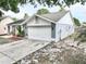 Charming single-story home with a well-manicured lawn, a two-car garage, and a welcoming front porch area at 11314 Silverleaf Ct, Riverview, FL 33579