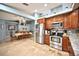 Eat-in kitchen features stainless appliances, tiled floor, wood cabinets, and adjacent dining area at 11314 Silverleaf Ct, Riverview, FL 33579