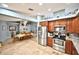 Kitchen featuring stainless steel appliances, tile floors, granite counters and wood cabinetry at 11314 Silverleaf Ct, Riverview, FL 33579