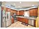 Modern kitchen with stainless steel appliances, granite countertops, and wooden cabinetry at 11314 Silverleaf Ct, Riverview, FL 33579