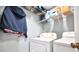 Functional laundry room with washer, dryer, and shelving for storage solutions at 11314 Silverleaf Ct, Riverview, FL 33579