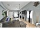 Open-concept living room with tile floors, large sectional sofa, fireplace, and vaulted ceiling at 11314 Silverleaf Ct, Riverview, FL 33579