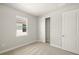 Bright bedroom features a window, closet, and neutral carpet flooring at 11359 Boundless Ter, Venice, FL 34293