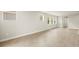 Bright living room with tile flooring, neutral walls, and large windows offers a modern and airy feel at 11359 Boundless Ter, Venice, FL 34293