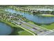 Scenic aerial view of the gated community entrance, with palm-lined streets and a tranquil lake at 11375 Boundless Ter, Venice, FL 34293