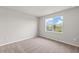 Bright bedroom featuring a view of the lake, neutral walls, and carpeted floors at 11375 Boundless Ter, Venice, FL 34293
