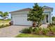 Two-car garage with patterned driveway and manicured landscaping on a sunny day at 11375 Boundless Ter, Venice, FL 34293
