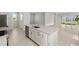 Kitchen island in modern open plan, with sink and modern hardware at 11375 Boundless Ter, Venice, FL 34293