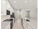 Modern kitchen featuring stainless steel appliances, white cabinets, and light countertops at 11375 Boundless Ter, Venice, FL 34293