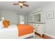 Cozy bedroom with a ceiling fan, warm light, and a dresser with a stylish mirror at 11404 2Nd N St # 3, St Petersburg, FL 33701