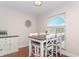 Bright dining area showcases arched window, a wooden table and seating, with a view outside at 11404 2Nd N St # 3, St Petersburg, FL 33701