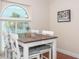 Comfortable eat-in kitchen features an arched window, a dark wood table, and seats for four at 11404 2Nd N St # 3, St Petersburg, FL 33701