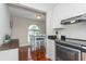 Cozy eat-in kitchen shows stainless appliances and a dining area by an arched window at 11404 2Nd N St # 3, St Petersburg, FL 33701
