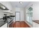 Bright kitchen features white cabinets, stainless steel appliances, and a large arched window for ample natural light at 11404 2Nd N St # 3, St Petersburg, FL 33701