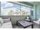Screened patio features outdoor seating and serene neighborhood views at 11404 2Nd N St # 3, St Petersburg, FL 33701