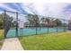 Gated tennis courts with rules posted and bench seating enhance the community's outdoor amenities at 11404 2Nd N St # 3, St Petersburg, FL 33701