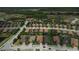 Aerial view showcasing a well-planned community layout with homes, green spaces, and a lake at 11489 Bitola Dr, Odessa, FL 33556