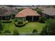 Aerial view showcasing a home's well-maintained backyard, screened patio, and lush landscaping at 11489 Bitola Dr, Odessa, FL 33556