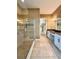 Bathroom with walk-in shower, double vanity, and a view to the walk-in closet at 11489 Bitola Dr, Odessa, FL 33556