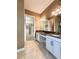 Bright bathroom featuring dual sinks with granite counters and large mirrors at 11489 Bitola Dr, Odessa, FL 33556