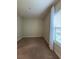 Cozy carpeted bedroom featuring a window with sheer curtains at 11489 Bitola Dr, Odessa, FL 33556