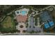 Aerial image showcasing a community clubhouse, pool, parking, and tennis courts, highlighting amenities at 11489 Bitola Dr, Odessa, FL 33556