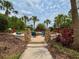 Community fire pit area surrounded by chairs, landscaping, and palm trees, ideal for gatherings at 11489 Bitola Dr, Odessa, FL 33556